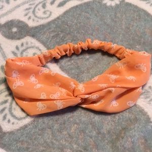 Orange stretchy headband with white bows